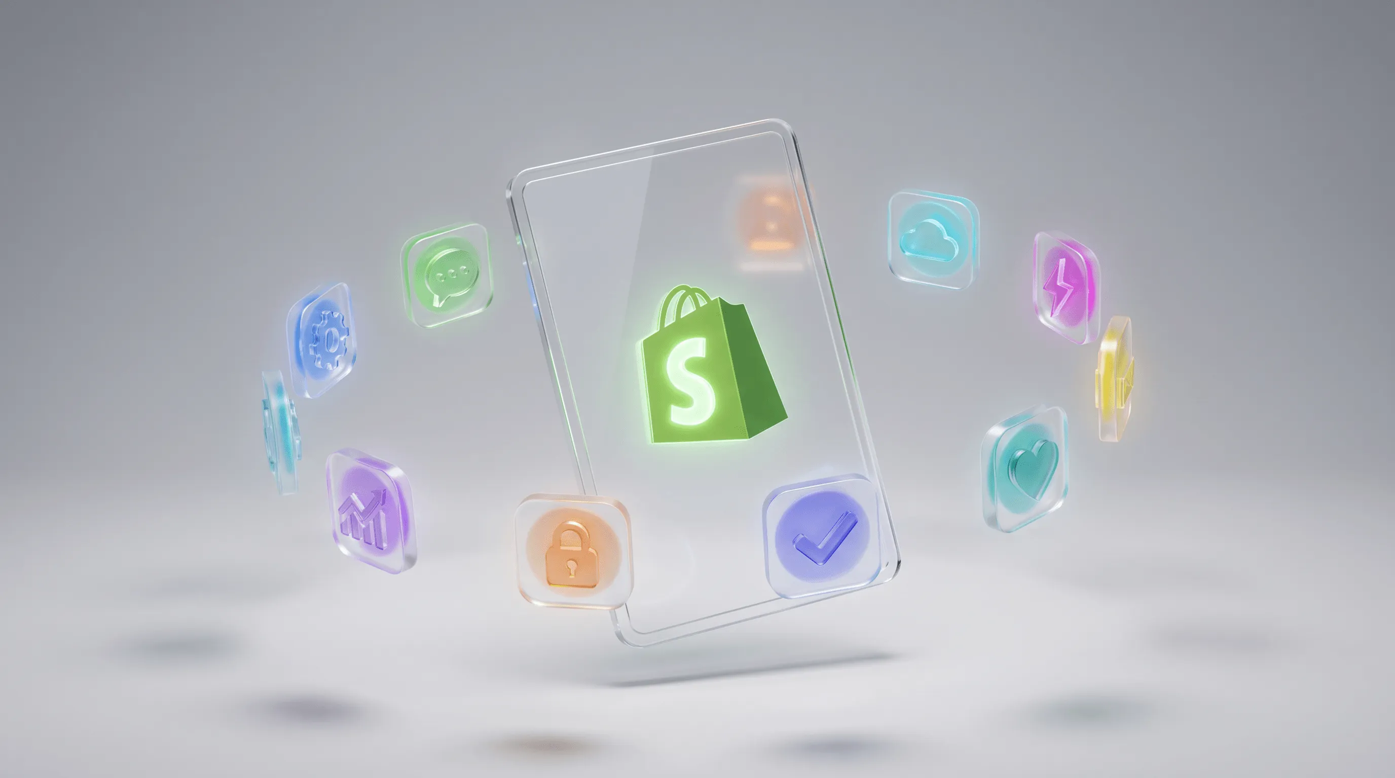 Die besten Shopify Apps – Glas-Tablet mit Shopify Logo umgeben von bunten Glas-App-Icons